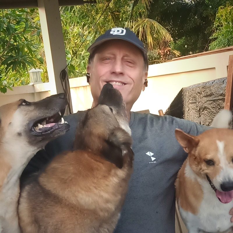 James Seymour, founder of AI Future Clarity, sitting outdoors with his dogs